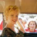 This shot of Marilyn Monroe was taken by Milton H Greene on the set of Bus Stop in 1957. Photographed from inside of a car, Marilyn is smiling at the camera as she is chauffeured through a crowd of people.